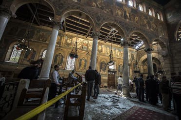 Egyptian security forces and members of the clergy inspect the scene of a bomb explosion at the Saint Peter and Saint Paul Coptic Orthodox Church on December 11, 2016, in Cairo's Abbasiya neighbourhood. AFP