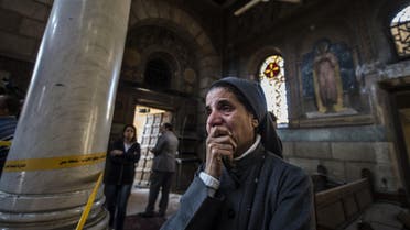 A nun reacts as Egyptian security forces (unseen) inspect the scene of a bomb explosion at the Saint Peter and Saint Paul Coptic Orthodox Church on December 11, 2016, in Cairo's Abbasiya neighbourhood. The blast killed at least 25 worshippers during Sunday mass inside the Cairo church near the seat of the Coptic pope who heads Egypt's Christian minority, state media said. KHALED DESOUKI / AFP