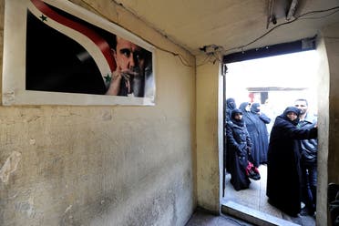 Civilians wait outside a government military police centre to visit their relatives, who were evacuated from the eastern districts of Aleppo and are being prepared to begin their military service, in Aleppo, Syria December 11, 2016.
