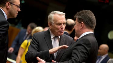 French Foreign Minister Jean-Marc Ayrault (center), speaks with Slovakian Foreign Minister Miroslav Lajcak, right, during a round table meeting of EU foreign ministers at the EU Council building in Brussels on Monday, Dec. 12, 2016. (AP)