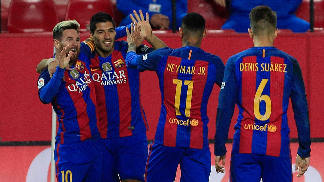 Barcelona's Messi, left, celebrates with teammate Luis Suarez, second left, after scoring against Sevilla during their La Liga soccer match between Sevilla and Barcelona at the Sanchez Pizjuan stadium, in Seville, Spain on Sunday, Nov. 6, 2016. (AP