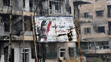 A general view shows a poster of Syria's President Bashar al-Assad in Aleppo's Bustan al-Qasr neighbourhood after Syrian pro-government forces captured the area in the eastern part of the war torn city on December 13, 2016. After weeks of heavy fighting, regime forces were poised to take full control of Aleppo, dealing the biggest blow to Syria's rebellion in more than five years of civil war.  George OURFALIAN / AFP
