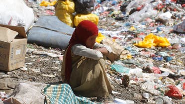 A girl sits on a pile of rubbish at landfill site on the outskirts of Sanaa, Yemen November 16, 2016. (Reuters