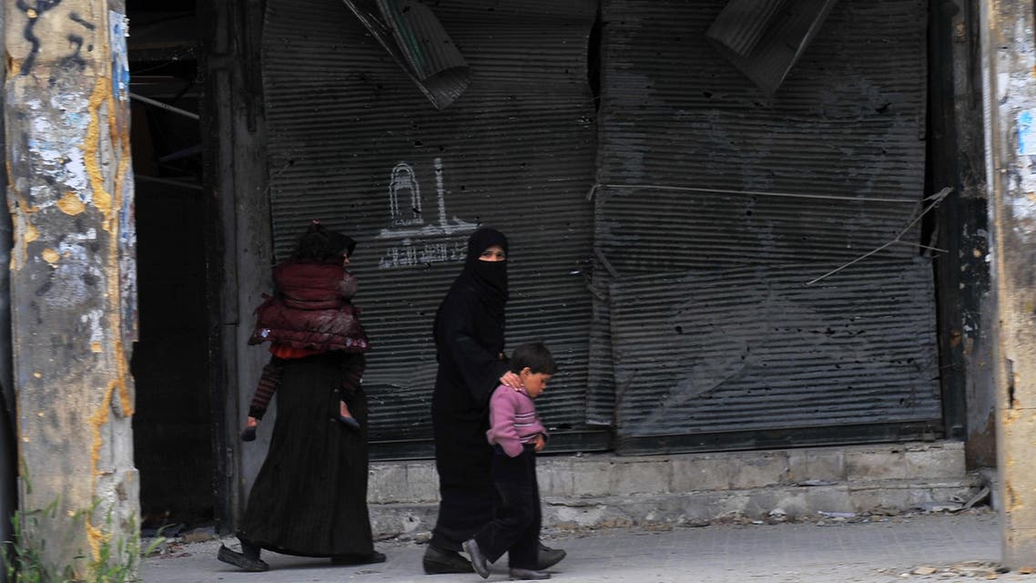 Syrian women walk with their children in the northern Syrian city of Aleppo on March 23, 2013. In Aleppo, nine months into fighting that has devastated many districts, life has slowly started to return to what passes for normal in Syria today. AFP