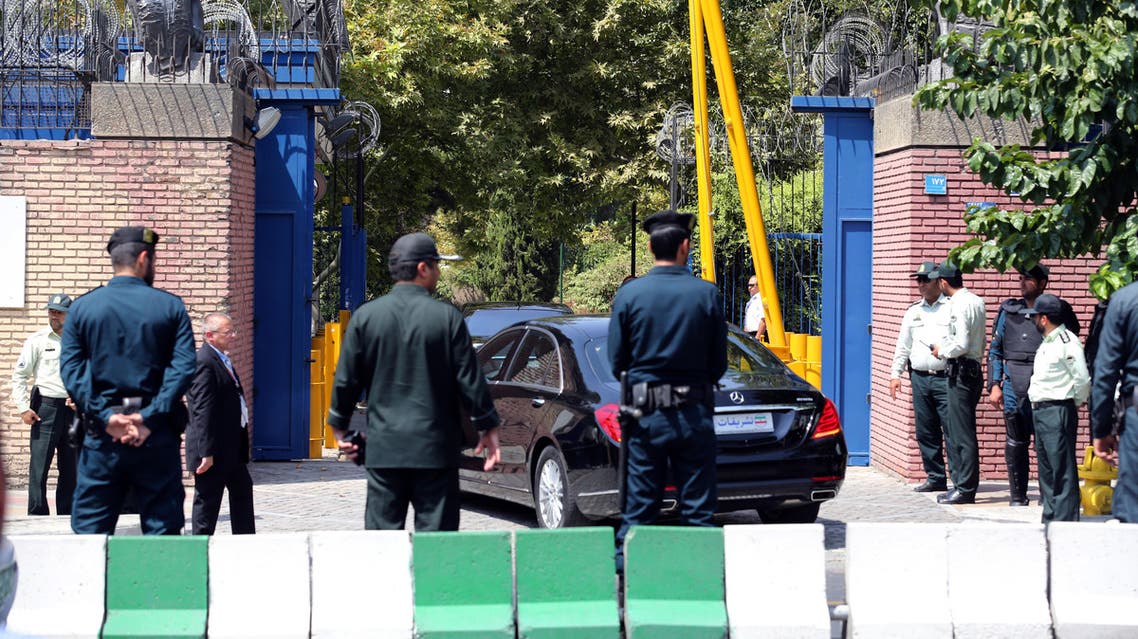 Iranian security forces stand guard as Britain's Foreign Secretary Philip Hammond arrives in his car at the British embassy on August 23, 2015 in the capital Tehran. AFP