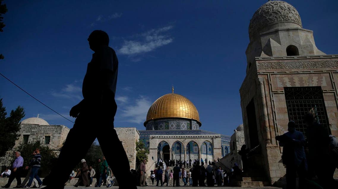 A Palestinian man walks past the Dome of Rock at the Al-Aqsa Mosque compound after the Friday prayer in Jerusalem's Old City on November 11, 2016. AHMAD GHARABLI / AFP