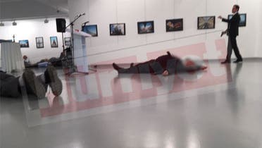 image from @Hurriyet from moment after shooting of Russia's ambassador to Ankara at an art opening