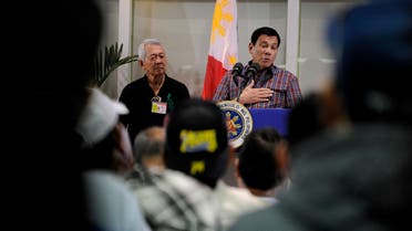 Philippine President Rodrigo Duterte (C) speaks to overseas Filipino workers (OFW) during the welcoming of repatriated OFWs from Saudi Arabia at the Manila International Airport in Manila on August 31, 2016. (AFP)