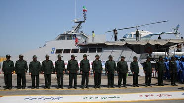 Members of Iran's Revolutionary Guard stand in front of a newly inaugurated high-speed catamaran, in the port city of Bushehr, northern Persian Gulf, Iran, Tuesday, Sept. 13, 2016.