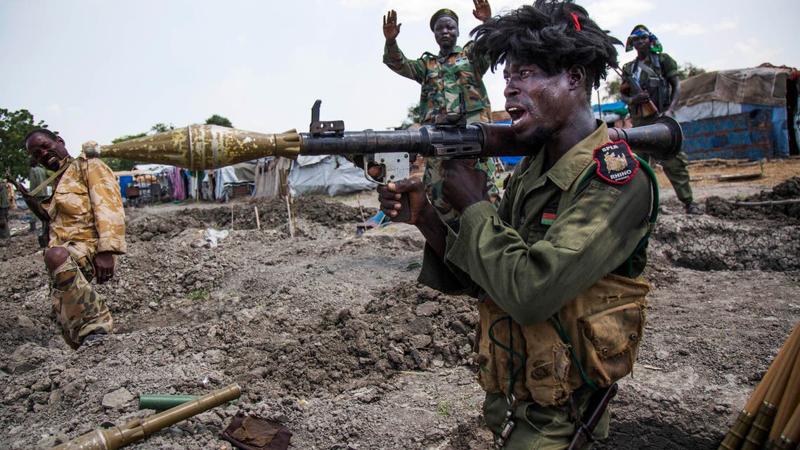 Soldiers of the Sudan People Liberation Army (SPLA) celebrate while standing in trenches in Lelo, outside Malakal, northern South Sudan, on October 16, 2016. (AFP)
