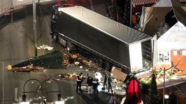  Police search the surroundings of a truck which run into a crowded Christmas market the evening before and killed several people in Berlin, Germany, early Tuesday, Dec. 20, 2017. (Michael Kappeler/dpa via AP)