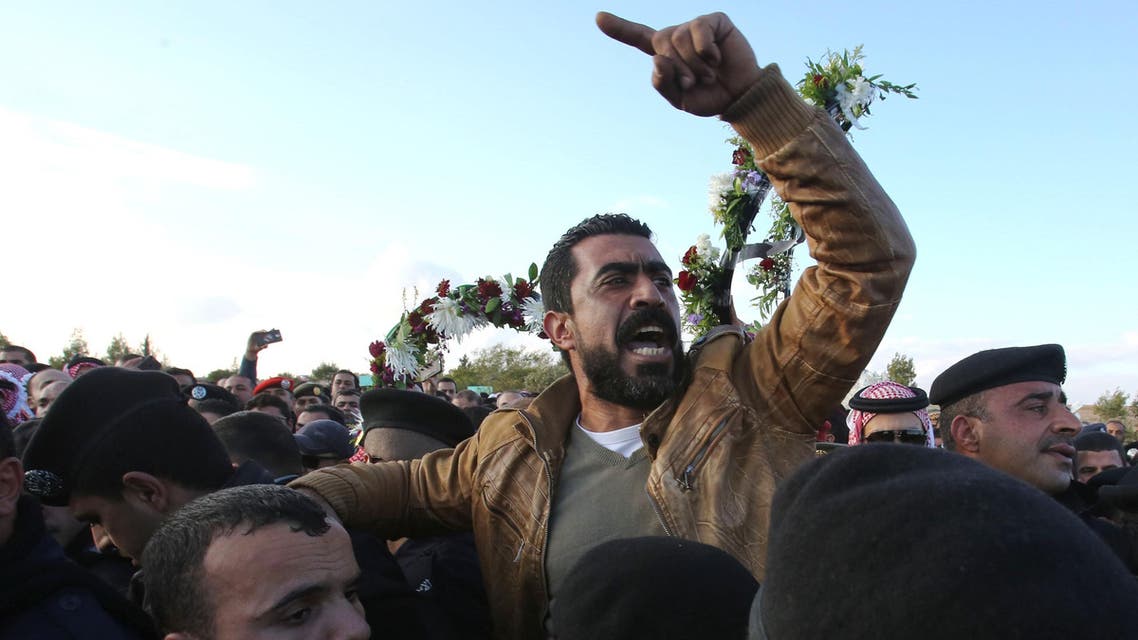 Jordanians react on december 19, 2016 during the funeral of victims who were killed a day earlier in an attack at in Karak, a tourist destination, around 120 kilometres (70 miles) south of the capital Amman. Jordanian police said they found suicide belts and other explosives in the hideout of suspected Islamic State group jihadists behind an attack that killed 10 people, including a Canadian tourist. Another 34 people were wounded in Sunday's shooting spree, including a second Canadian. Four gunmen were shot dead by police during the course of a siege lasting several hours. KHALIL MAZRAAWI / afp