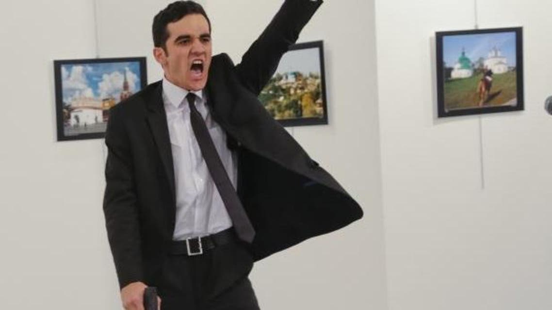 A gunman gestures after shooting the Russian ambassador to Turkey, Andrei Karlov, at a photo gallery in Ankara, Turkey, Dec. 19, 2016. (AP Photo/Burhan Ozbilici)