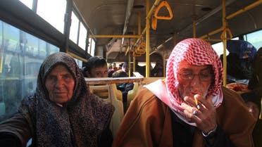 Residents from the mostly Shiite Syrian villages of Kafraya and Fuaa, which are besieged by opposition fighters, wait in a bus to get a green light from the rebels to cross into a government controlled area in the province of Aleppo, on December 20, 2016. Some 750 people had been evacuated in parallel from the embattled city of Aleppo, from Fuaa and Kafraya, two Shiite-majority villages in northwest Syria besieged by rebels, as part of the deal to evacuate civilians. afp 