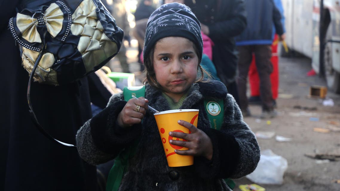 A Syrian girl, who was evacuated from the last rebel-held pockets of Syria's northen city of Aleppo, eats upon arriving on December 20, 2016 in the opposition-controlled Khan al-Assal region, west of the embattled city. At least 25,000 people have left the bombed-out eastern districts of Syria's Aleppo since evacuations began last week, the International Committee of the Red Cross said. Baraa Al-Halabi / AFP