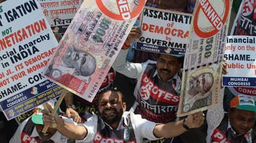 An Indian protestor holds placards of banned 500 and 1000 rupee notes during a protest against demonetization, in Mumbai on November 28, 2016. (AFP)