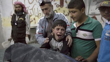 A young boy cries as he sits with a relative who was killed (Picture: AFP/Getty Images)  Read more: http://metro.co.uk/2016/04/28/patients-and-doctors-dead-after-airstrikes-hit-hospital-in-syria-5846987/#ixzz4TYWt9yQP
