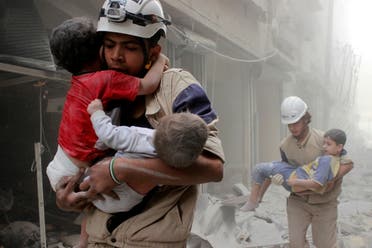 Members of the Civil Defence rescue children after what activists said was an air strike by forces loyal to Syria's President Bashar al-Assad in al-Shaar neighbourhood of Aleppo, Syria June 2, 2014. REUTERS/Sultan Kitaz/File Photo