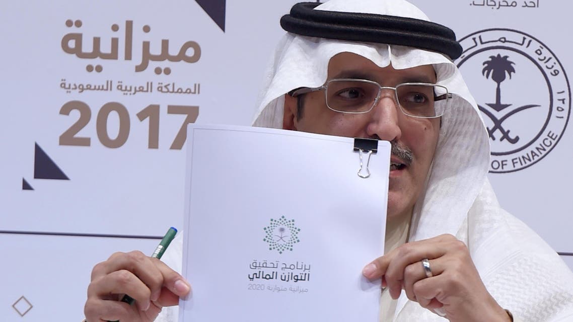 Saudi Finance Minister Mohammed Al-Jadaan shows documents during a press conference to unveil the country’s national budget for 2017 on December 22, 2016 in Riyadh. (AFP)