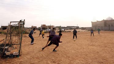 Young people from the city of Sirte, 450 kilometres east of the Libyan capital Tripoli, play football after returning to the outskirts of the city. (AFP)