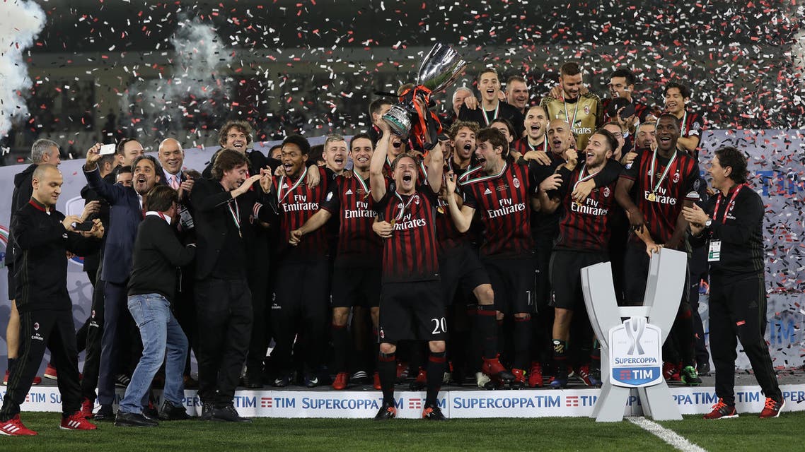 AC Milan's players celebrate winning against Juventus during the Italian Super Cup final match between AC Milan and Juventus in Doha on December 23, 2016. AC Milan beat Juventus to win the Italian Super Cup in a penalty shootout, the first trophy the Rossoneri have won since 2011. (AFP)