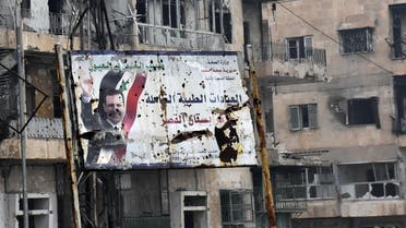 A general view shows a poster of Syria's President Bashar al-Assad in Aleppo's Bustan al-Qasr neighbourhood after Syrian pro-government forces captured the area in the eastern part of the war torn city on December 13, 2016. afp