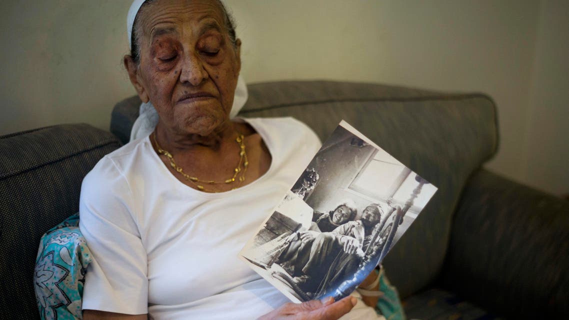 This Monday, July 11, 2016, photo shows Yemen born Jewish Israeli Yona Josef weeping in her home in Raanana, Israel. Josef wept as she clutched an old picture of herself as a child in Yemen and recounted losing her sister. (AP)