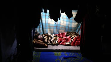 A displaced Iraqi child from the Shabak community, who fled fighting between Islamic State (IS) group jihadists and Peshmerga fighters around the northern Iraqi city of Mosul, sleeps inside a tent at the Baharka camp, 10 kms west of Arbil, the capital of the Kurdish autonomous region in northern Iraq, on January 16, 2015. AFP 