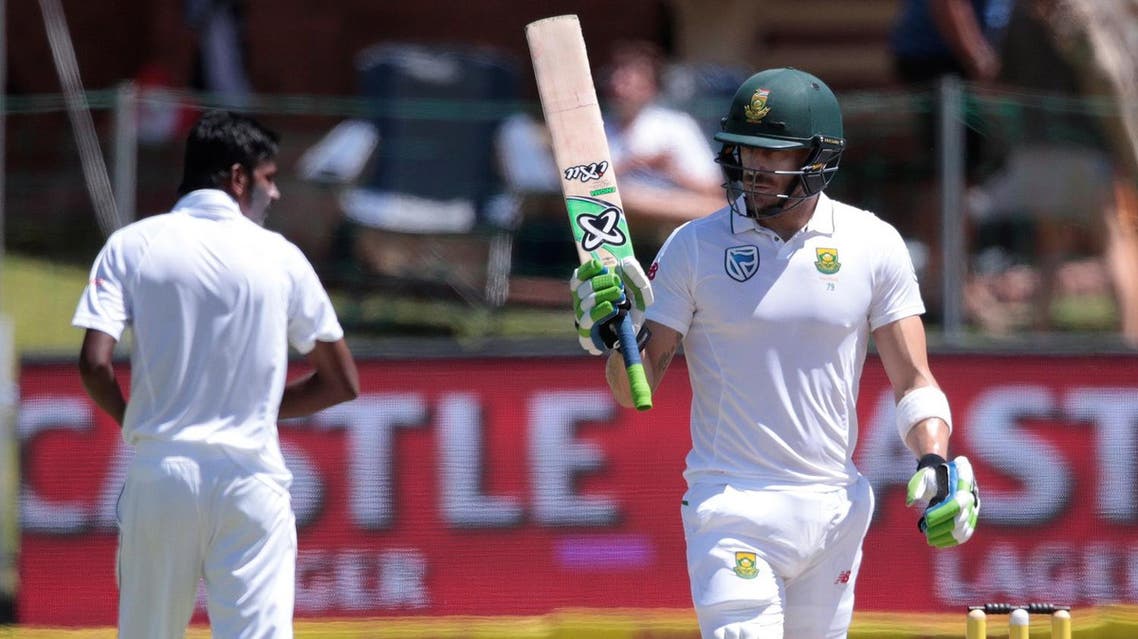 South African batsman and Captain Faf du Plessis (R) raises his bat as he celebrates scoring half century (50 runs) during the fourth day of the first Test between South Africa and Sri Lanka. (AFP)