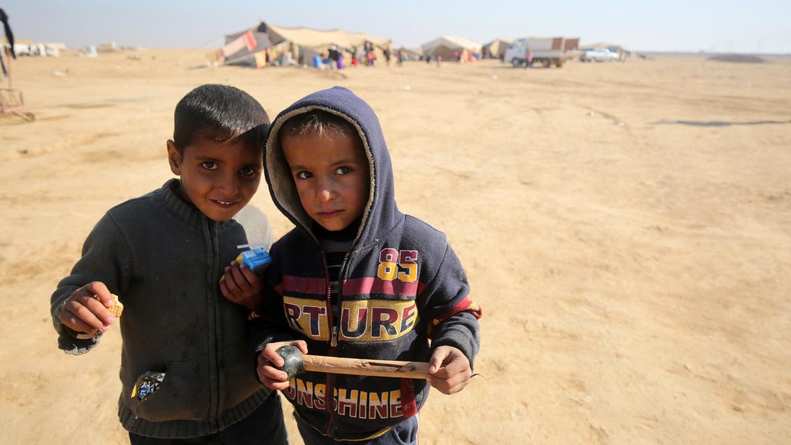 Displaced Iraqi children, from the outskirts of the city of Tal Afar, pose at a makeshift camp on December 12, 2016 in the village of Khalif Saleh, south of Tal Afar. (AFP)