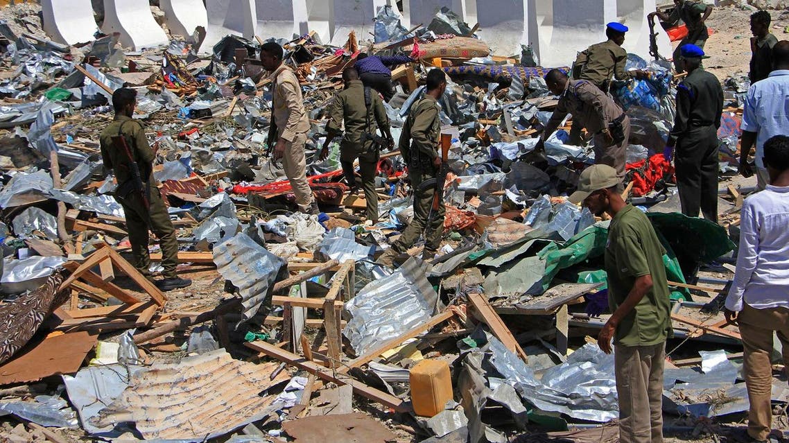 Somali soldiers filter through the debris of a destroyed building near the scene of a suicide car bomb attack in Mogadishu, Somalia, Monday, Jan, 2, 2017. A suicide bomber detonated an explosives-laden vehicle at a security checkpoint near Mogadishu's international airport Monday, killing at least three people, a Somali police officer said. (AP Photo/Farah Abdi Warsameh)