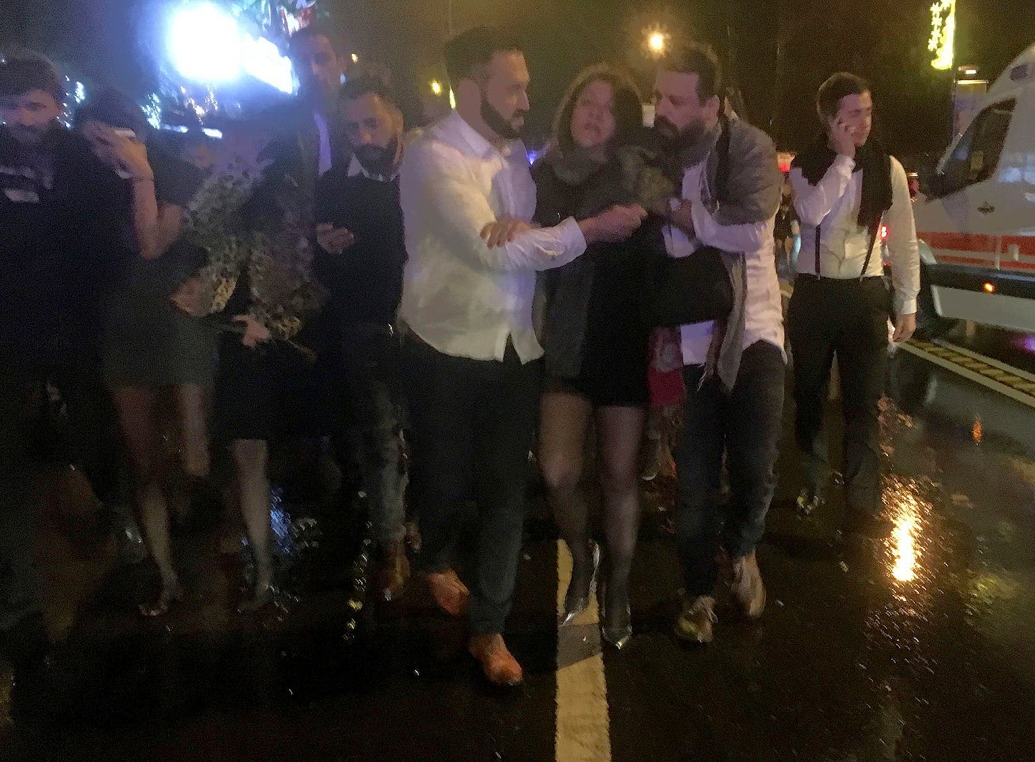 People leave the nightclub, the scene of an attack in Istanbul, early Sunday, Jan. 1, 2017 (DHA-Depo Photos via AP)
