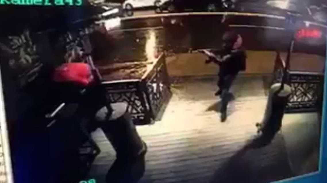 The gunman (Right) fires on a bystander during the Istanbul New Year's Eve massacre (AFP PHOTO / CCTV / STRINGER)