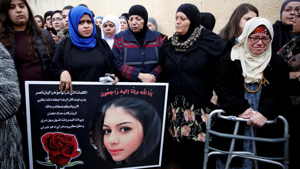 Relatives and friends mourn as they hold a placard with a picture of Leanne Nasser, who was killed in an Istanbul nightclub attack, outside the family house at the Israeli town of Tira, Israel January 3, 2017. REUTERS/Ronen Zvulun