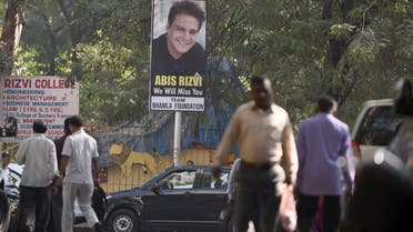 Pedestrians walk past a hoarding put up in memory of deceased Indian businessman and film producer Abis Rizvi ahead of his funeral in Mumbai on January 4, 2017. (AFP)