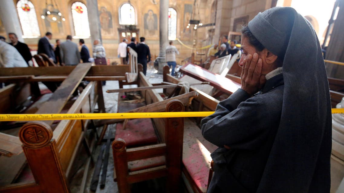 A nun cries as she stands at the scene inside Cairo's Coptic cathedral, following a bombing, in Egypt December 11, 2016. REUTERS