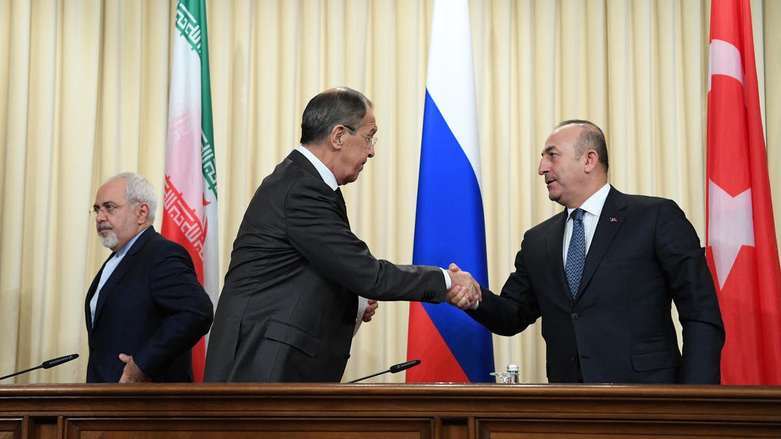 Russian Foreign Minister Sergei Lavrov (C) shakes hands with his Turkish counterpart Mevlut Cavusoglu (R) as Iran’s Foreign Minister Mohammad Javad Zarif (L) looks on after a news conference in Moscow on December 20, 2016. (AFP)