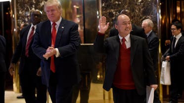 President-elect Donald Trump stands with SoftBank Group Corp. founder and Chief Executive Officer Masayoshi Son in the lobby of Trump Tower on December 6, 2016 in New York. (AFP)