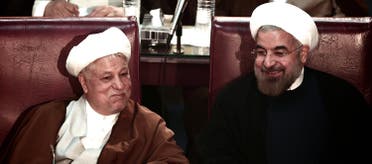 Iranian President Hassan Rowhani (R) chats with former president Akbar Hashemi Rafsanjani during a session of the Assembly of Experts in Tehran on September 3, 2013. (AFP)