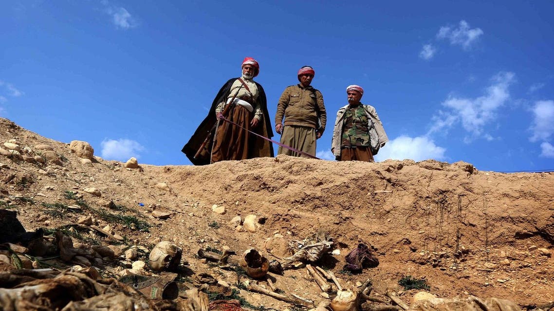 Members of the Yazidi minority search for clues on February 3, 2015, that might lead them to missing relatives in the remains of people killed by ISIS. (AFP)