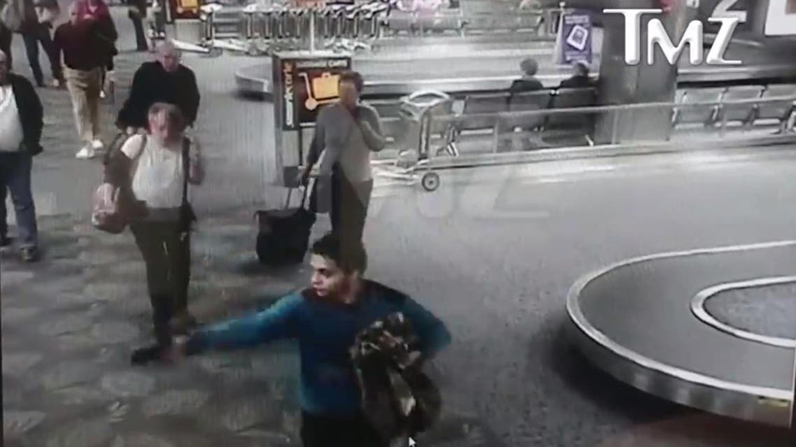 Video released by the TMZ website showed Santiago, bearded and wearing a blue shirt, walking calmly through the airport. (TMZ screengrab)