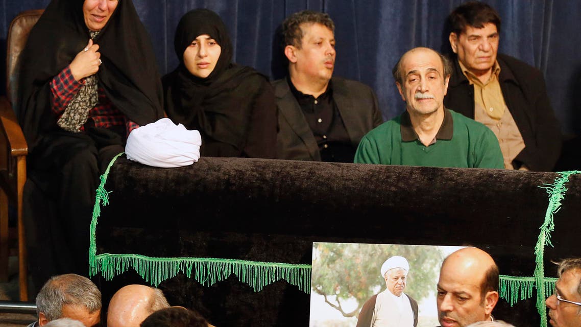 Mehdi Hashemi Rafsanjani (C) and Fatemeh Hashemi Rafsanjani (L), the children of late former Iranian president Akbar Hashemi Rafsanjani, gather with mourners around Rafsanjani’s coffin during a mourning ceremony at Jamaran mosque in Tehran, on January 8, 2017. (AFP)