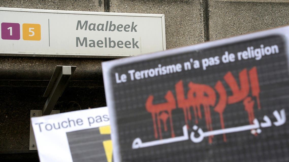 A member of the Muslim Community of Belgium holds up a sign reading "Terrorism has no religion" as people take part in a tribute, called by Muslim organizations, to the victims of the March 22 Brussels terror attacks on April 9, 2016, outside of the Maelbeek / Maalbeek metro station, Brussels