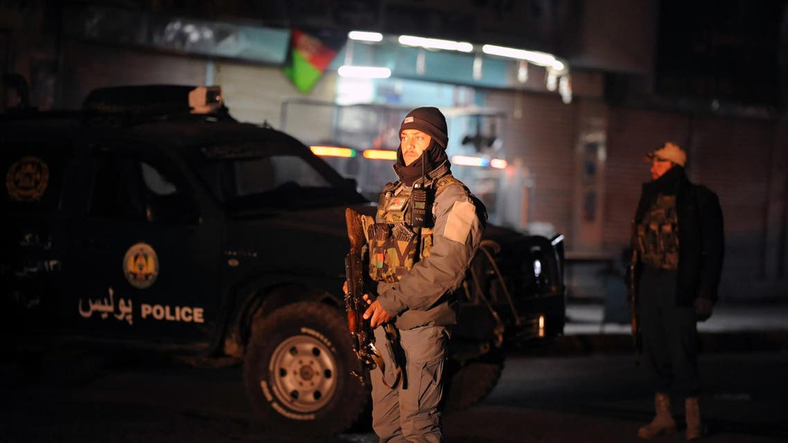 This picture taken on January 10, 2017 shows Afghan policemen standing guard at the site of an explosion near the governor's compound in Kandahar قندهار الإمارات الامارات