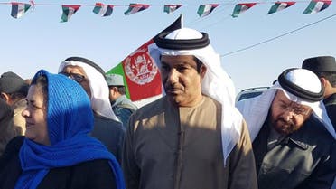 UAE Ambassador Juma Mohammed Abdullah al-Kaab, center, stands next to Nasrin Oryakhil, left, Afghanistan's minister of Labor, Social Affairs, Martyrs and Disabled, during an official ceremony of the Foundation for Khalifa bin Zayed Al Nahyan orphanage in Kandahar, Afghanistan. AP
