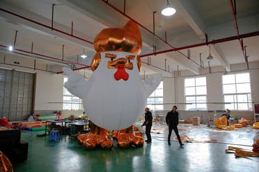 Workers show to visitors an inflatable chicken that local media say bears resemblance to U.S. President-elect Donald Trump as their factory braces for the Year of the Rooster in Jiaxing, Zhejiang province, China January 12, 2017. REUTERS
