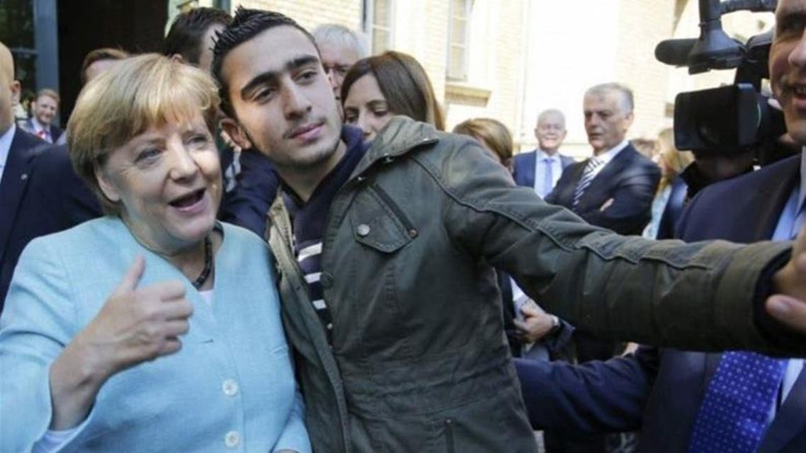Anas Modamani takes a selfie with Angela Merkel in Berlin in September 2015. Photograph