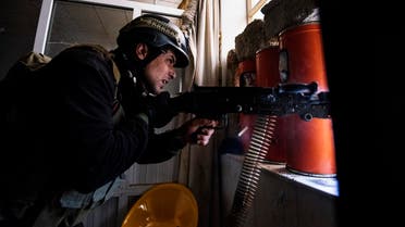 A member of the Iraqi special forces' Counter-Terrorism Service (CTS) fires his machine gun as he holds a position inside Mosul's university. (AFP)