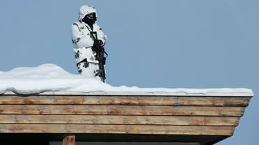 Swiss special police officer observes the area from atop the roof of the Congress Hotel ahead of the annual meeting of the World Economic Forum (WEF) in Davos. (Reuters)
