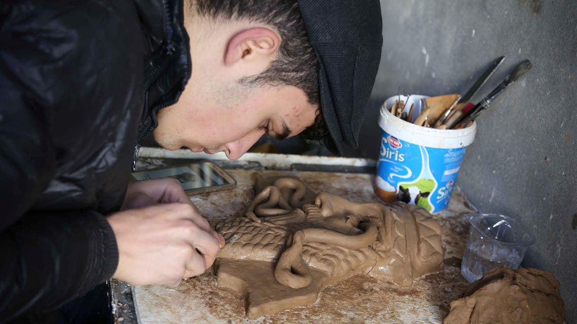Ninos Thabet, an 18-year-old Christian who studied art at Mosul University, creates miniature replicas of statues destroyed by militants when they overran the 3,000-year-old Assyrian city of Nimrud 2-1/2 years ago, in Erbil, Iraq, January 13, 2017. Picture taken January 13, 2017. REUTERS